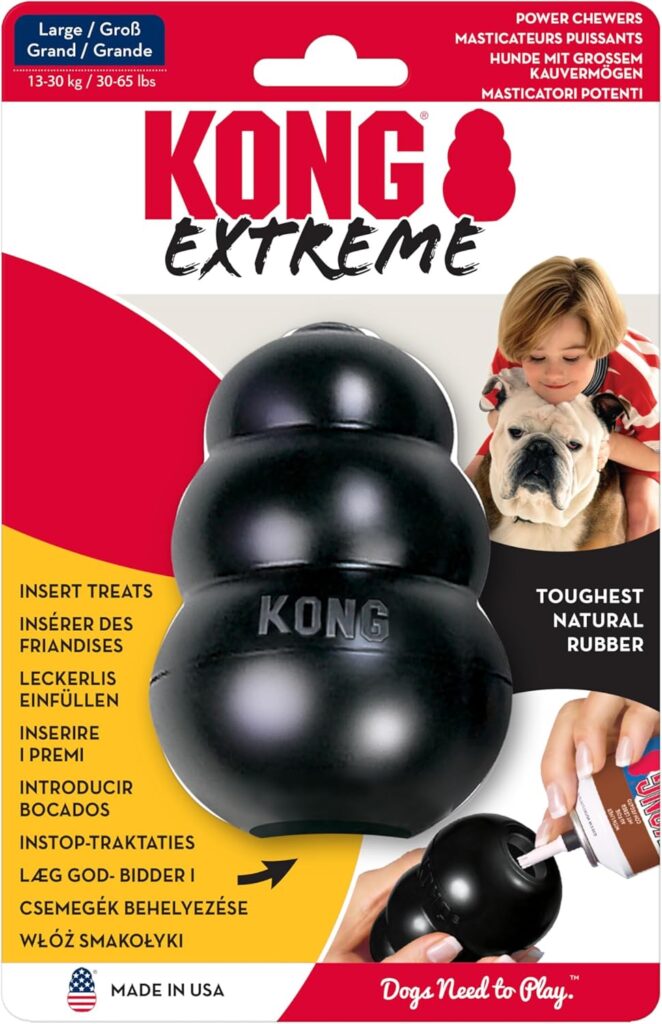 5 Best Safe Chews Bones for Dogs Under $40 17 A Kong Extreme dog toy with a dog's paw resting on it, showcasing the toy's durability and appeal to pets.